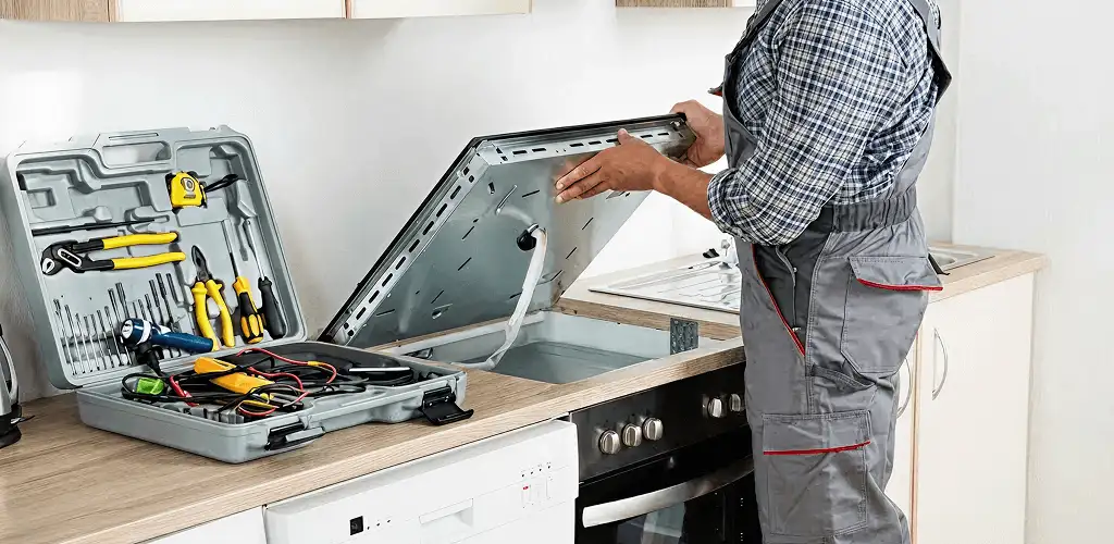 Handyman repairing a cooktop and checking wiring connections in Charleston, SC