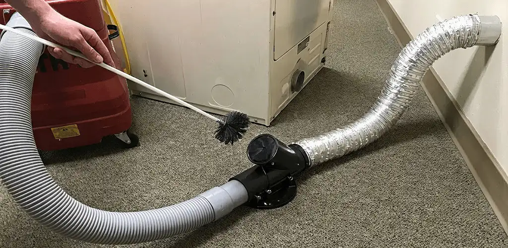 Dryer vent cleaning service removing lint from a dryer duct connection in Charleston, SC