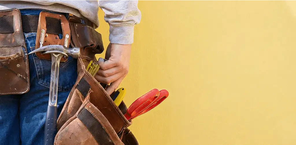 Handyman with tool belt ready for home repairs and maintenance in Charleston, SC