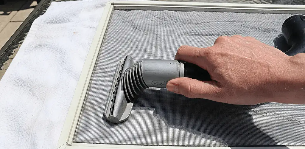 Window screen repair cleaning and fixing a damaged screen mesh in Charleston, SC